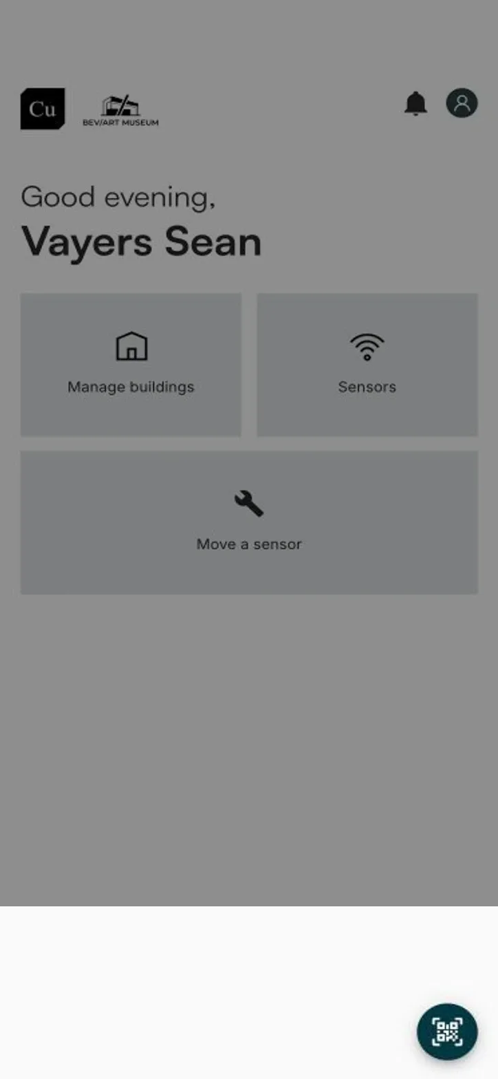 The mobile home screen with the round QR button in the bottom right corner